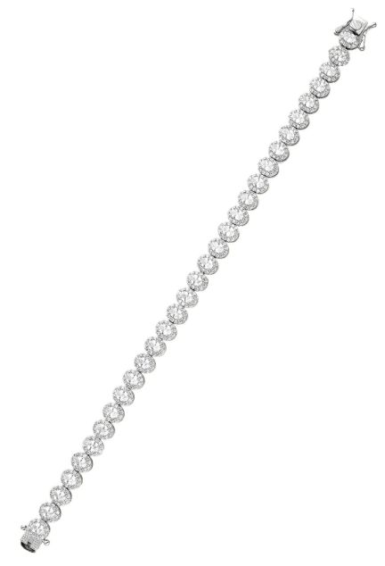 Pulsera plata y circonitas tipo riviere, este modelo esta formado por rosetas u orlas con una circonita central talla oval engastada en garra de cuatro patas y rodeada por una  galería de circonitas redondas de mucho menor tamaño vista extendida