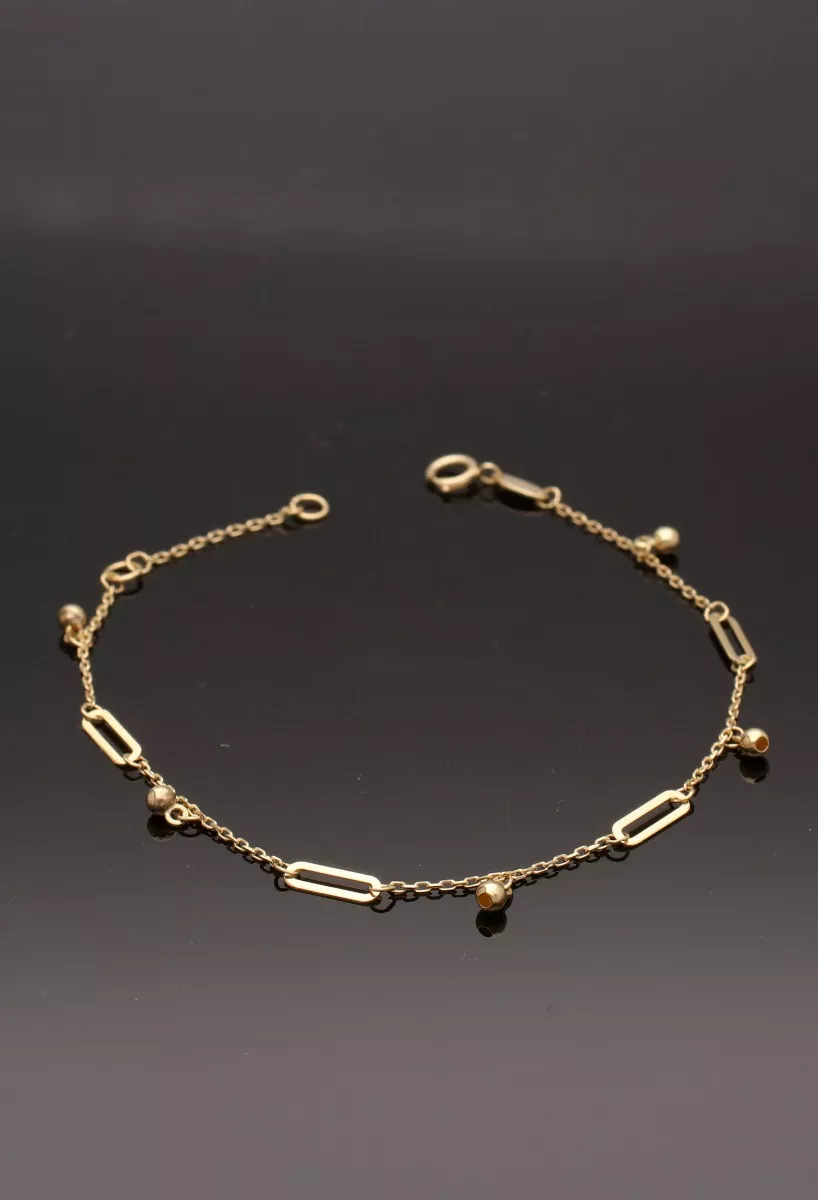 Pulsera oro amarillo 18 ktes 289_0157788PU pulsera oro amarillo 18 ktes con entrepiezas y fetiches foto sobre fondo negro